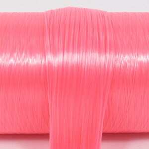 A bright pink high quality nylon doll hair for rerooting dolls, monster high reroots, standard 11.5 inch fashion dolls, custom rehairing and restoring all doll and toy types.