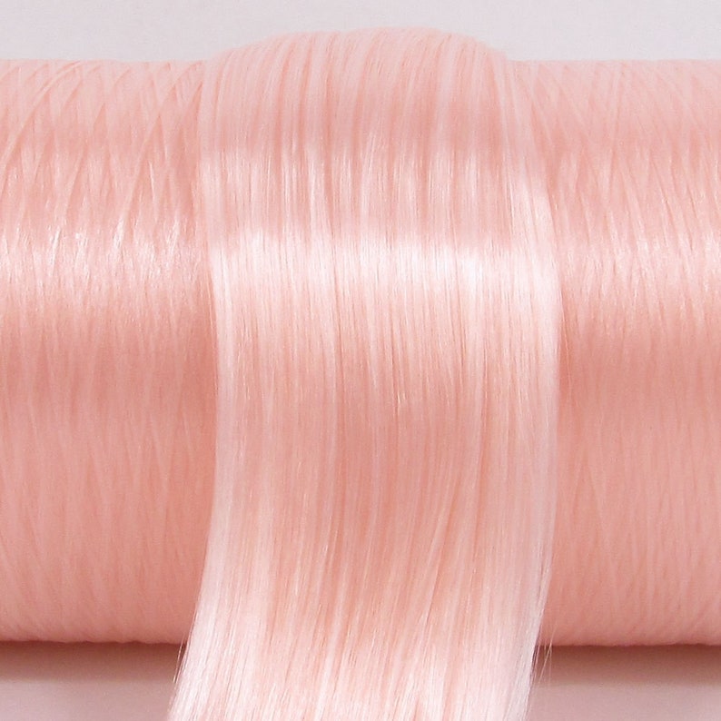 A pale, light pink high quality nylon doll hair for rerooting dolls, monster high reroots, standard 11.5 inch fashion dolls, custom rehairing and restoring all doll and toy types. A great match for RH Bella!