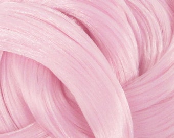 May include: Close-up of a pink slime with a smooth, silky texture. The slime is folded and twisted, creating a swirling pattern.
