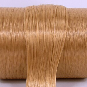 A light brown high quality nylon doll hair for rerooting dolls, monster high reroots, standard 11.5 inch fashion dolls, custom rehairing and restoring all doll and toy types.