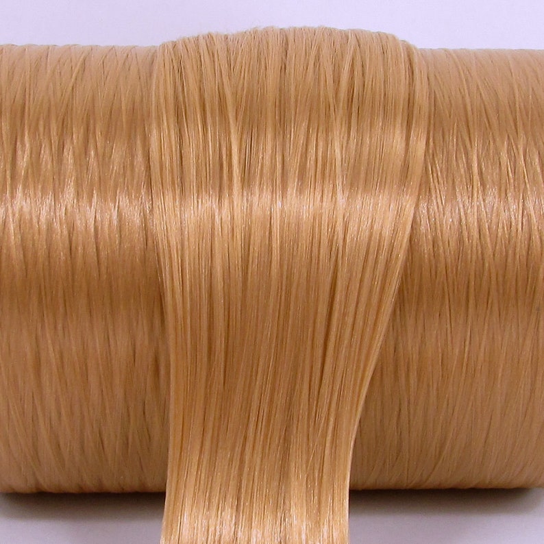 A light brown high quality nylon doll hair for rerooting dolls, monster high reroots, standard 11.5 inch fashion dolls, custom rehairing and restoring all doll and toy types.