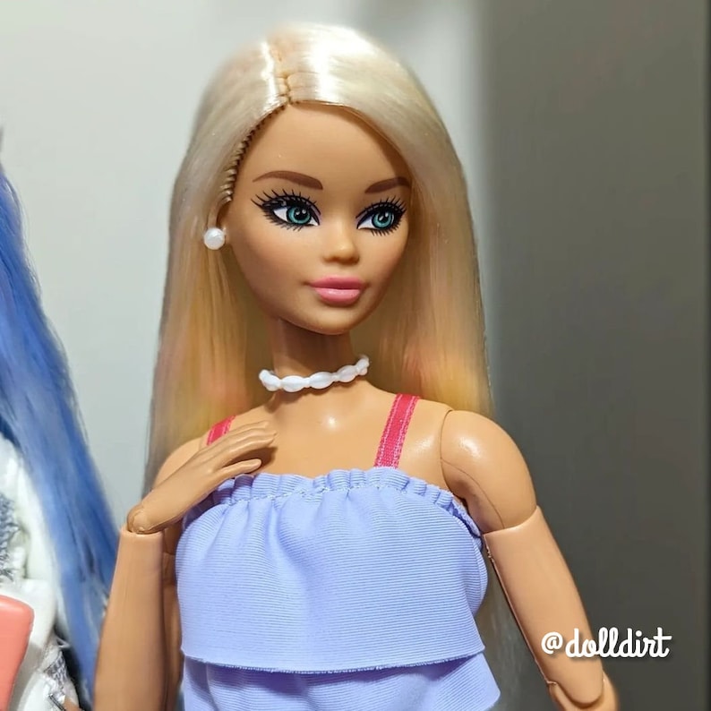 A pale blonde nylon doll hair for rerooting dolls, monster high reroots, standard 11.5 inch fashion dolls, custom rehairing and restoring all doll and toy types. Example Barbie reroot shown.  Doll not included.