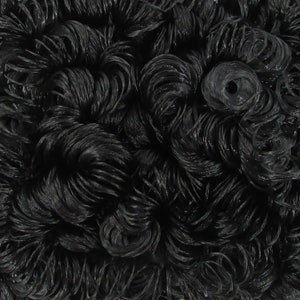 May include: Close-up of a black curly wig made of synthetic hair. The wig is styled in a short, curly bob.