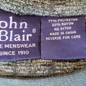 May include: A blue label with white text that reads "John Blair Fine Menswear Since 1910". A second blue label with white text reads "77% Polyester 23% Rayon RN 81700 Made in China Reverse for Care".