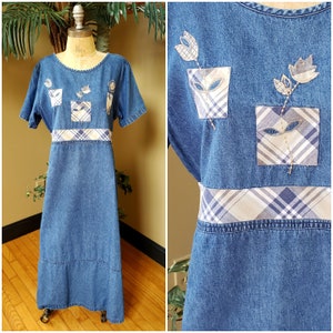 May include: A long denim dress with a plaid trim and embroidered floral details. The dress has short sleeves and a round neckline.