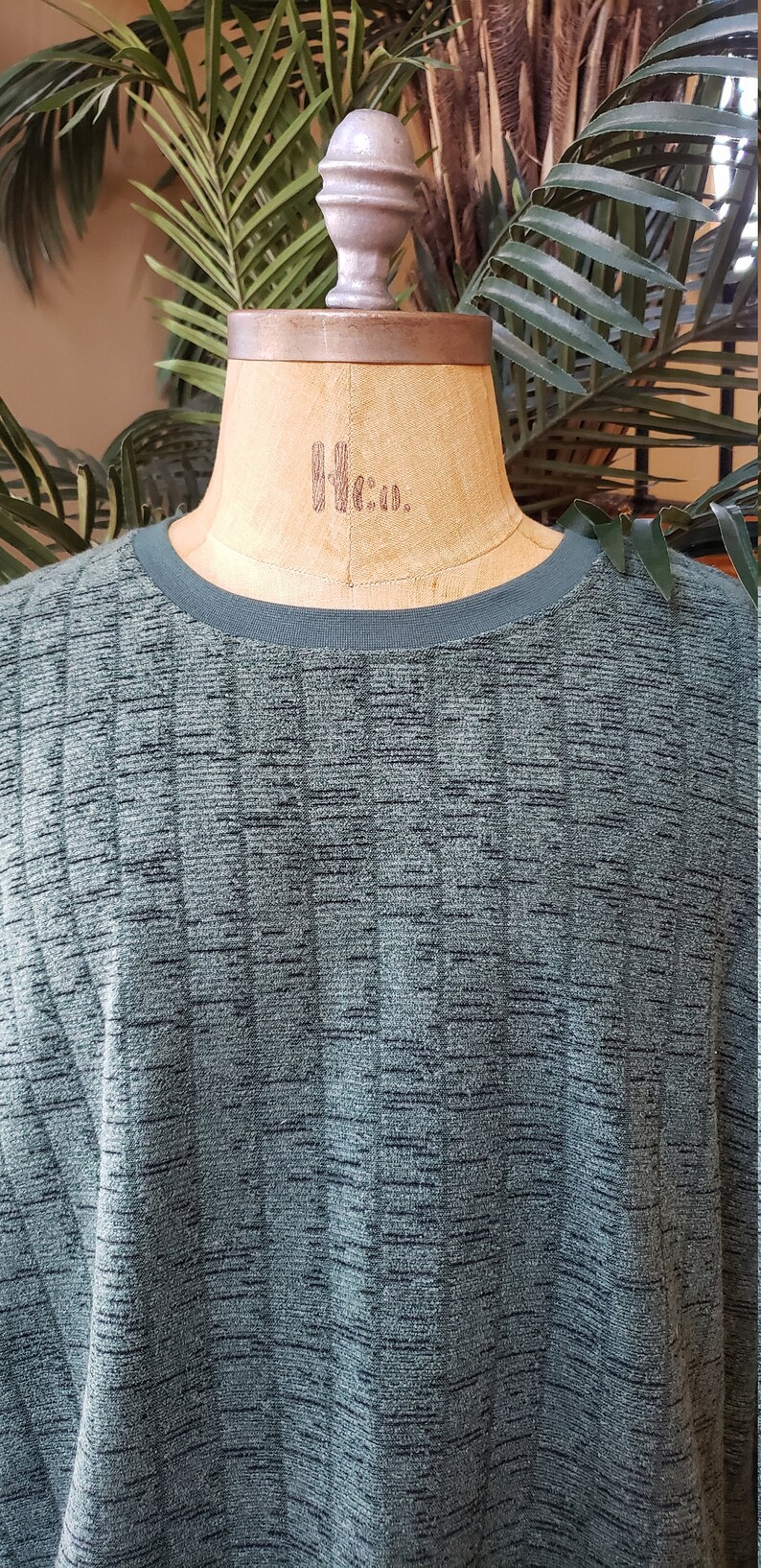 May include: A dark green, textured, long-sleeved shirt with a ribbed pattern.
