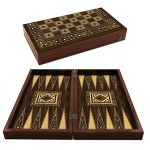 May include: A wooden backgammon board featuring intricate marquetry inlay. The closed exterior displays a checkerboard pattern, while the open interior reveals a dark wood surface with light wood triangular points and central geometric motifs.