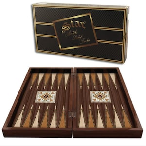 May include: A wooden backgammon board with a dark brown finish, featuring inlaid light and dark wood triangular points and a central geometric mother-of-pearl design. The set includes a black rectangular box labeled Star Antik Sedef Tavla.