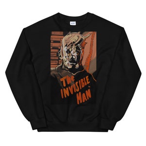 May include: Black sweatshirt featuring a graphic print of a monstrous, pale-skinned figure with a stitched-up face. The graphic is in a vintage style and includes the text "The Invisible Man".