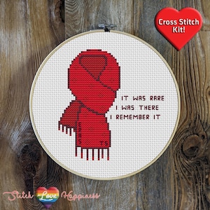 May include: Cross stitch pattern featuring a red scarf with the text "It was rare I was there I remember it".