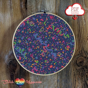 May include: A colorful cross-stitch pattern with a dark blue background and a variety of bright colors, including orange, green, pink, and purple. The pattern is framed in a wooden hoop.