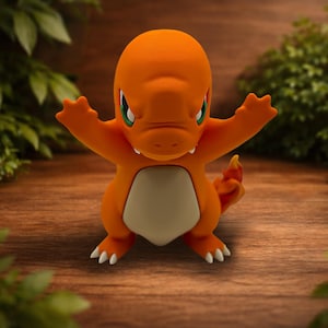 May include: A small orange figurine of a bipedal creature with a cream-colored belly, green eyes, and a flame-tipped tail. The figure has its arms raised in a pose, featuring sharp white claws on its feet and a smooth, matte-textured surface.
