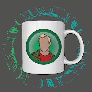 May include: White ceramic mug with a cartoon illustration of a person with blonde hair and a red shirt, set within a green circle. The person is wearing a camouflage jacket. The mug has a curved handle and is set against a grey background with green and teal accents.