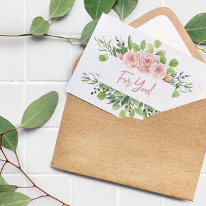 May include: A kraft paper envelope with a white card inside. The card has a watercolor illustration of pink roses and green leaves. The text "For You!" is written in pink on the card.