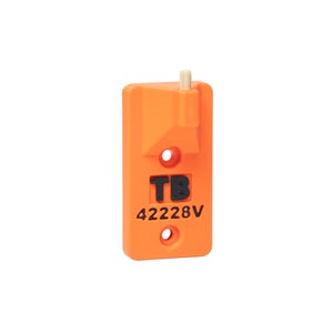 May include: A rectangular orange plastic component featuring a small beige cylindrical protrusion at the top, two circular mounting holes, and the black embossed text TB 42228V centered on the front surface of the device.