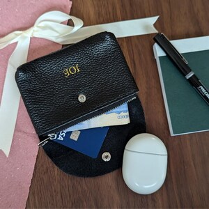 Black coin purse with personalisation and a zipper pouch.