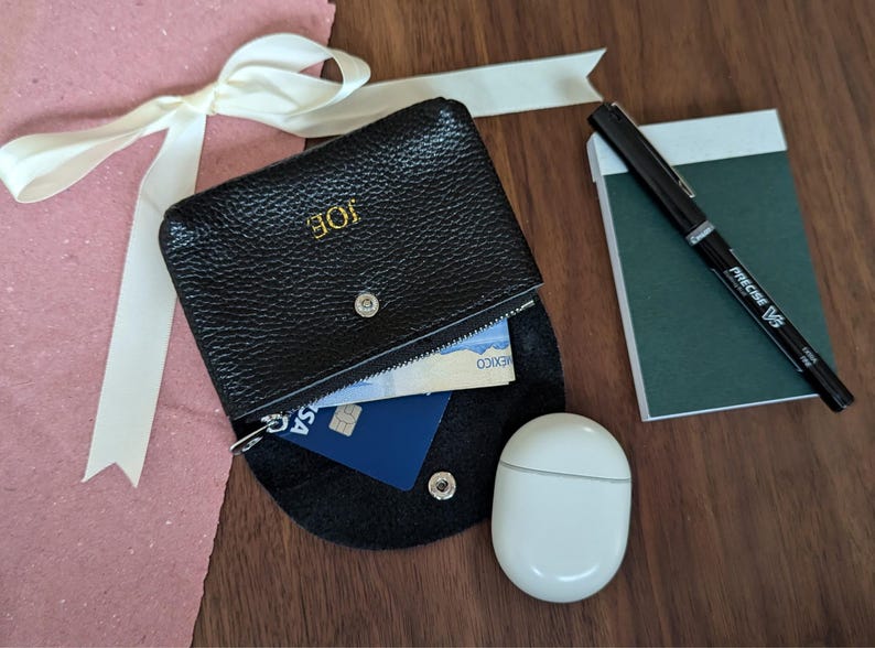 Black coin purse with personalisation and a zipper pouch.