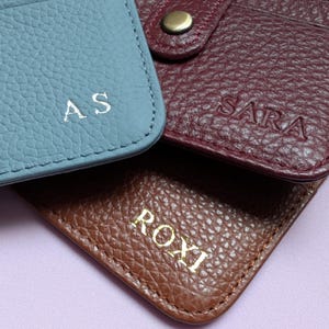 Navy Card holder with keychain showing the front and brown keyring holder showing the back.