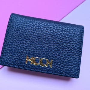 Close up of navy blue business card holder with a custom logo