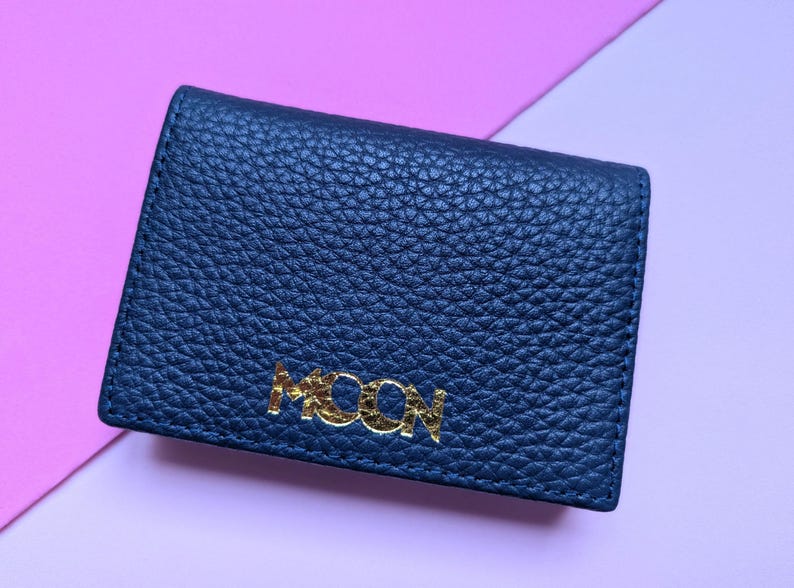 Close up of navy blue business card holder with a custom logo