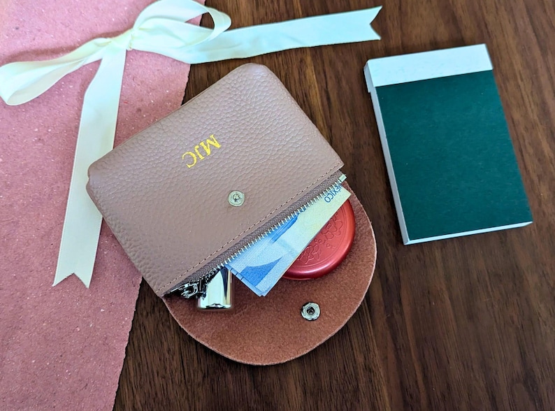 Soft pink coin purse with zipper and custom initials in gold.