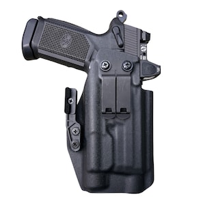 May include: A black polymer holster with a black handgun inside. The holster has a belt clip and a magazine carrier.