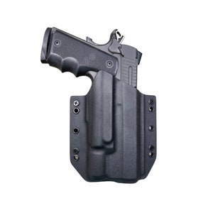 May include: A black polymer holster with a black handgun inside. The holster has multiple adjustable retention screws and a belt loop.