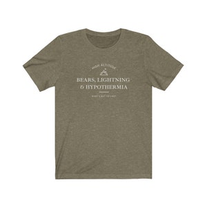 May include: A green t-shirt with a white graphic that says "High Altitude - Bears, Lightning & Hypothermia - What's not to like?" The graphic also includes a mountain peak symbol.