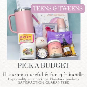 May include: A gift box filled with self-care items for teens and tweens. The box includes a pink tumbler, a bath bomb, body wash, hair mask, a jar of body scrub, a bottle of essential oil, and a lip balm. The box is decorated with the words "Teens & Tweens" and "Pick a Budget".