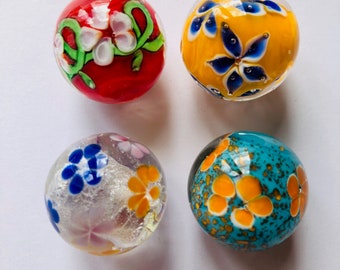 Collection of four exquisite hand made glass marbles 22mm