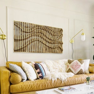 May include: A mustard yellow leather sofa with a white faux fur throw and several patterned pillows. The sofa is in a living room with a white coffee table, a white rug, and a potted plant.