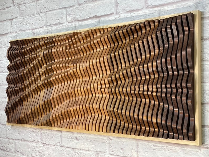 May include: A large wooden wall art piece made of multiple curved pieces of wood in shades of brown. The wood is arranged in a wave pattern, creating a 3D effect.