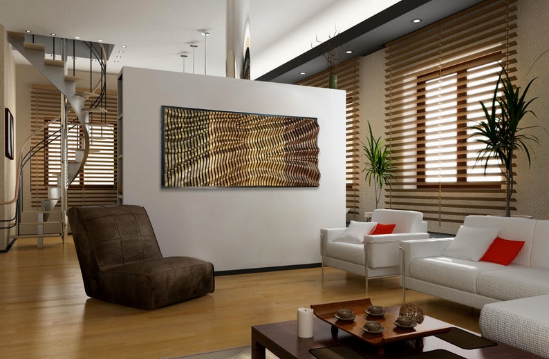 May include: A modern living room with a brown leather chair, two white couches with red pillows, and a wooden coffee table. A large abstract wall art piece with a gold and brown geometric pattern hangs on the wall.