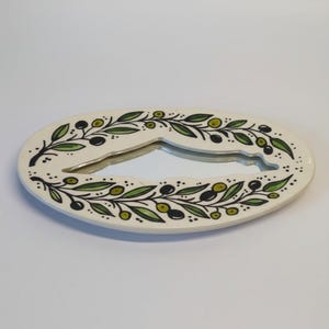 Decorative letter 'O' with floral design on a white background
