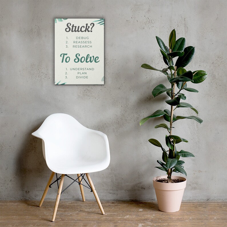 May include: A rectangular canvas print with the text "Stuck?" and "To Solve" in green. The print lists steps for problem-solving: Debug, Reassess, Research, Understand, Plan, and Divide. A white chair and a potted plant are in the image.