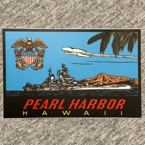 May include: A vintage-style sticker featuring a navy blue battleship sailing in front of a volcano and palm trees. The sticker has a blue background with white clouds and the text "PEARL HARBOR HAWAII" in red and black.