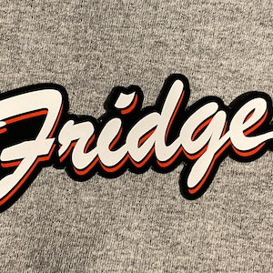 May include: White text with a red outline on a black background that reads "Fridge" in a stylized font.