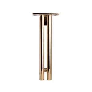 May include: A gold metal table leg with a rectangular base and two vertical supports.