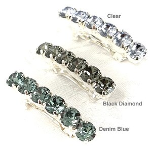 May include: Three silver hair clips with rows of rhinestones. The clips are shown in three different colors: clear, black diamond, and denim blue.