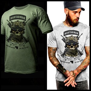 May include: A green and gray t-shirt with a skull graphic and the text "Mortarman Combat Ready Mess with the best Die like the best".