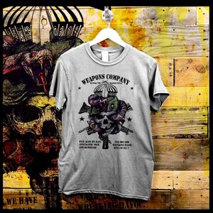 May include: Gray t-shirt with a skull and snake graphic. The text "WEAPONS COMPANY" is above the graphic, and the text "BORN TO RAISE HELL" is below the graphic. The text "ONCE AGAIN WE HAVE INFILTRATED YOUR LINE OF DEFENSE" is on the left side of the graphic, and the text "EVER LIKE NOW WREAKING HAVOC, WE'LL EM ALL!!" is on the right side of the graphic.