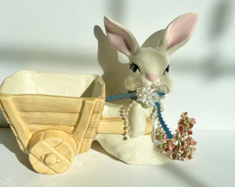 Holding a Blue Pot of Yellow Flowers Easter Vignette Vintage White Porcelain or Ceramic Easter Bunny or Rabbit Tabletop Decor Holding a Blue Pot of Yellow Flowers Easter Vignette Vintage White Porcelain or Ceramic Easter Bunny or Rabbit Tabletop Decor