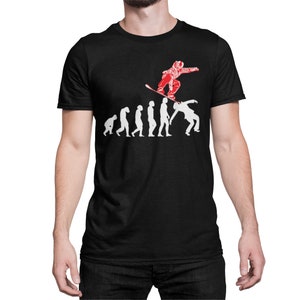 May include: A black t-shirt with a white graphic of a person snowboarding over a line of stick figures representing the evolution of humans. The text "Evolution of Snowboarding" is printed on the shirt.