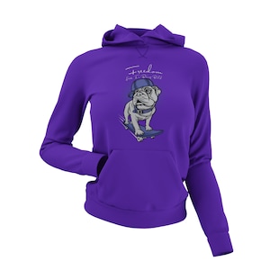May include: Purple hoodie with a graphic of a bulldog wearing a blue baseball cap and skateboarding. The text "Freedom like I'm Dog Roll" is printed on the hoodie.
