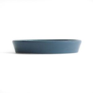 May include: A round, blue ceramic dish with a slightly raised rim.