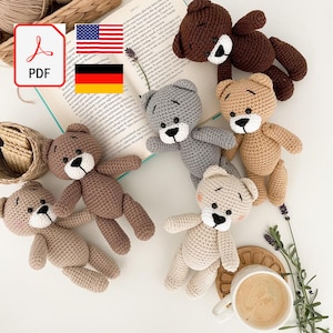 May include: A collection of handmade crochet teddy bears in various colors, including brown, gray, and beige. Each bear has a white muzzle and black eyes. A PDF icon and flags are also visible.