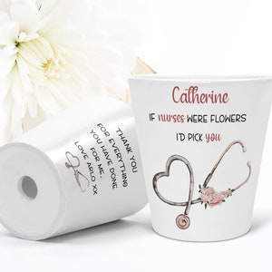 May include: White ceramic planter with a stethoscope and pink flowers design. The text "Catherine" and "IF nurses WERE FLOWERS I'D PICK YOU" is printed on the planter. The text "THANK YOU FOR EVERYTHING YOU HAVE DONE FOR ME, LOVE ARLO XX" is printed on the bottom of the planter.