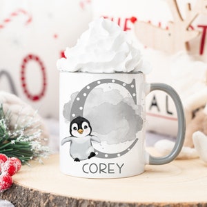 May include: White ceramic mug with a gray penguin illustration and the letter "C" with gray polka dots. The mug has the name "COREY" printed on the bottom.