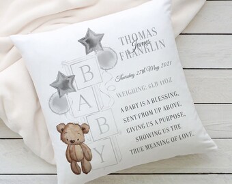 May include: A white pillow with a gray teddy bear and the words "BABY" spelled out in blocks. The pillow also includes the name "Thomas James Franklin", the date "Thursday 27th May 2021", and the weight "6LB 11OZ". The text reads "A baby is a blessing, sent from up above. Giving us a purpose, showing us the true meaning of love."