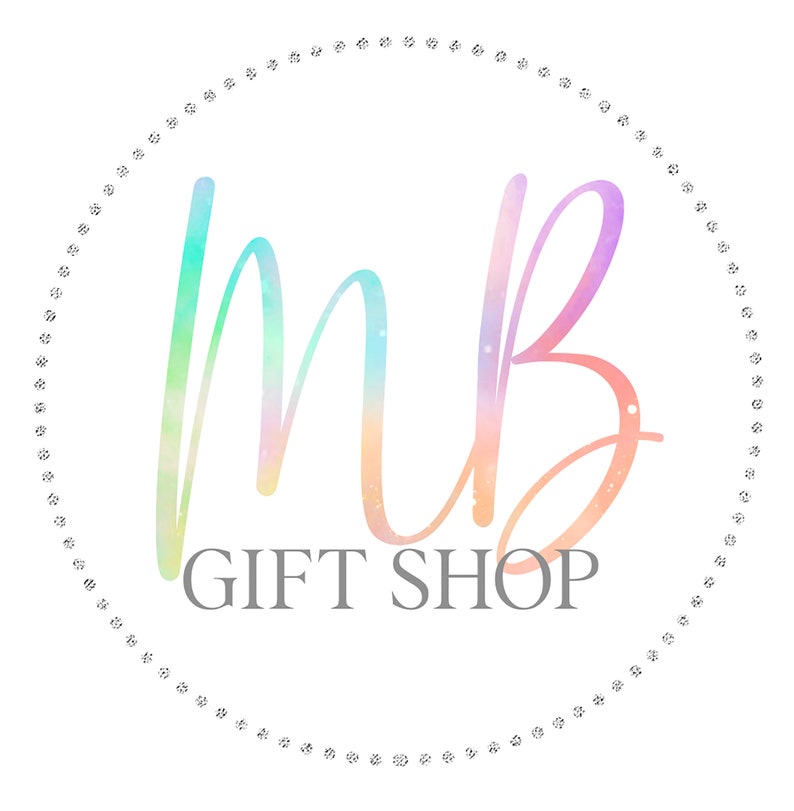 May include: A colorful logo with the letters "MB" in a rainbow gradient, surrounded by a circle of small white dots. The text "GIFT SHOP" is below the letters.